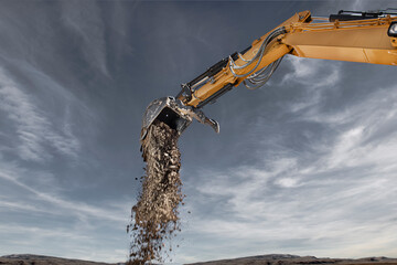 An excavator is digging on a construction site with cloudy blue sky.