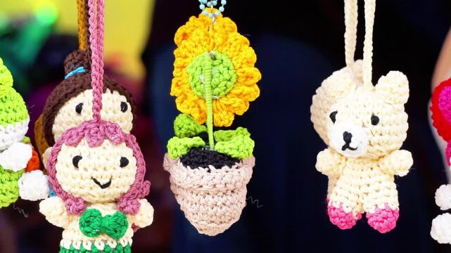 Keychain crafts made from knitting yarn hanging on display