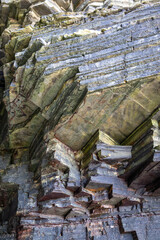Fototapeta premium Iconic natural rock formations of Playa de las Catedrales beach in Ribadeo, Lugo, Galicia, Spain, captured during low tide. A breathtaking seascape with caves and arches.
