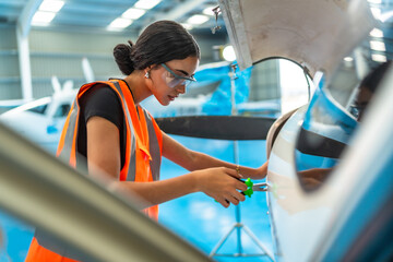 Skilled technician performing aircraft maintenance in hangar
