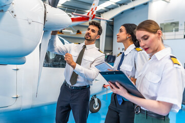 Aviation team conducting aircraft inspection in hangar
