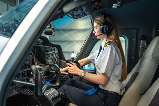 Female pilot using electronic flight bag in cockpit of small airplane