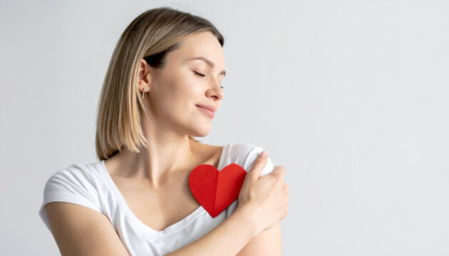 A serene woman embraces a red heart, symbolizing self-love and inner peace. She exudes a sense of tranquility and warmth - Powered by Adobe