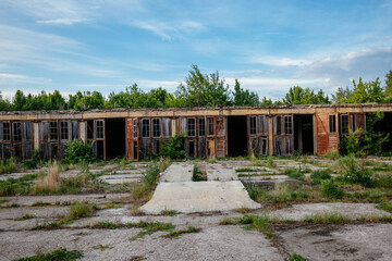 Old abandoned overgrown truck or tractor garages