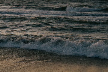 blurry photo of ocean against a sunset background. beauty in nature. sunset on the sea, a wave in motion. sunset, romantic walk. the poster.