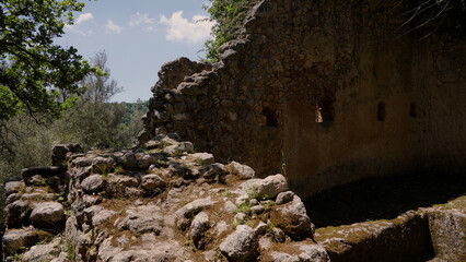 Moss covered rocks and crumbling walls characterize the ancient rupestrian settlement of Zungri,...