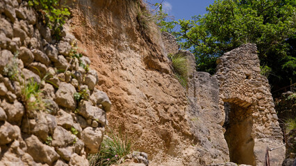 Ancient stone dwellings carved into the rock face at the rupestrian settlement of Zungri, Calabria, a unique historical site in southern Italy