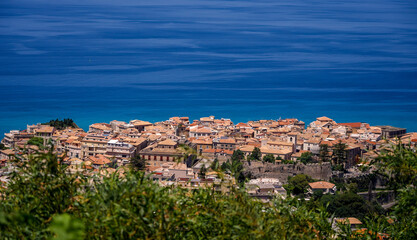 Fototapeta premium Panoramic view of Tropea, a charming town perched on a cliff overlooking the Tyrrhenian Sea, in the region of Calabria, Southern Italy