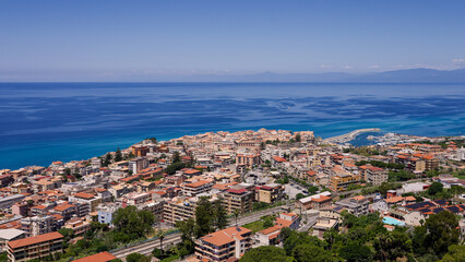 Obraz premium Aerial view of Tropea, a charming town perched on a cliff overlooking the Tyrrhenian Sea in Calabria, Southern Italy, enjoying a sunny summer day