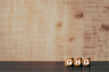 There is wood cube with the word GHG. It is an abbreviation for Greenhouse Gas as eye-catching...