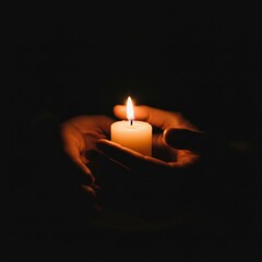 A Glowing Candle Held in Tender Hands: A Symbol of Hope and Remembrance in the Darkness