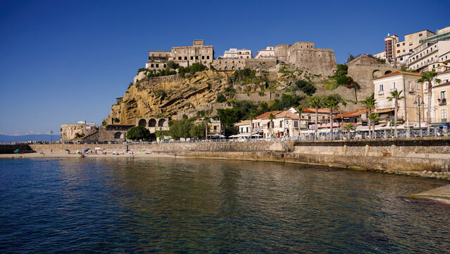 Pizzo Calabro's Murat Castle standing tall against a vibrant blue sky, showcasing its historical architecture and integration with the town's urban landscape