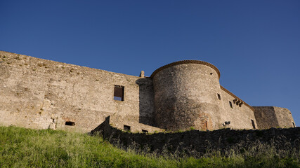 The imposing Norman Castle of Vibo Valentia rises majestically against a clear blue sky, showcasing...