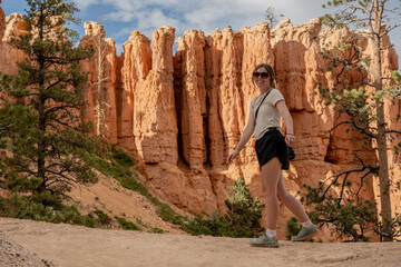 Young Woman Turns Back To Look At Camera Below The Hoodoos Of Bryce