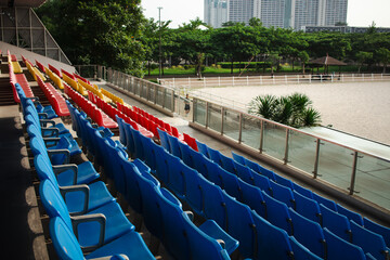 Fototapeta premium Colorful Empty Stadium Seats Overlooking Equestrian Arena