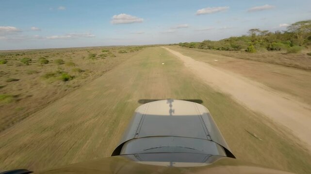 Hyperlapse of small plane taking off and flying over savannah in sunrise in Kenya
