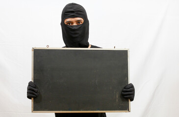 black clothed thief holding black board caught,isolated white background