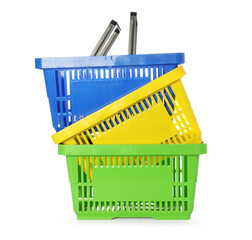 Fototapeta premium Stack of colorful shopping baskets isolated on white