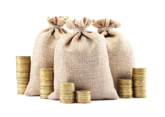 Bags and stacked coins isolated on white