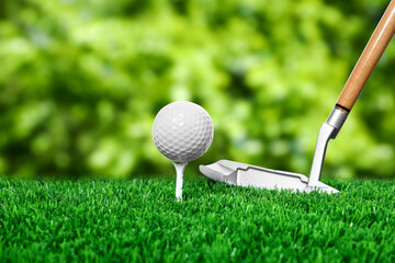 Golf ball on green grass and club outdoors, closeup