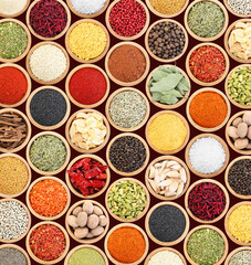 Set of different aromatic spices in bowls on black background, flat lay