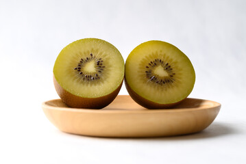 Fresh sungold kiwi fruit with wooden plate on white background, Healthy fruit