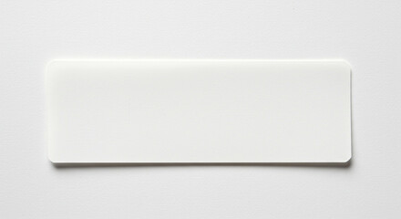 Blank white name tag isolated on white surface, ready for text or design