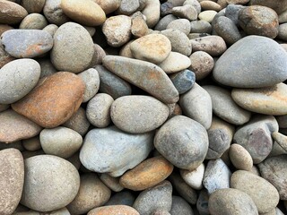Natural Smooth River Stones Background – Variety of Colors and Textures