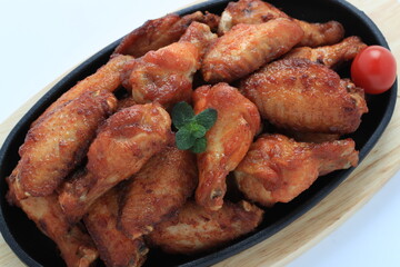 Korean-style fried chicken wings and drumsticks served in a skillet. Crispy texture with sweet and spicy glaze. A popular K-Food dish enjoyed at home and in restaurants.
