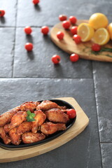 Korean-style fried chicken wings and drumsticks served in a skillet. Crispy texture with sweet and spicy glaze. A popular K-Food dish enjoyed at home and in restaurants.
