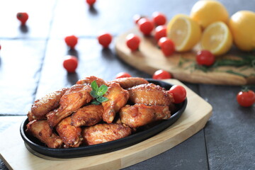 Korean-style fried chicken wings and drumsticks served in a skillet. Crispy texture with sweet and spicy glaze. A popular K-Food dish enjoyed at home and in restaurants.
