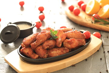 Korean-style fried chicken wings and drumsticks served in a skillet. Crispy texture with sweet and spicy glaze. A popular K-Food dish enjoyed at home and in restaurants.
