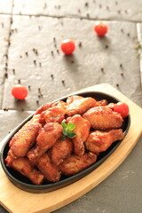 Korean-style fried chicken wings and drumsticks served in a skillet. Crispy texture with sweet and spicy glaze. A popular K-Food dish enjoyed at home and in restaurants.
