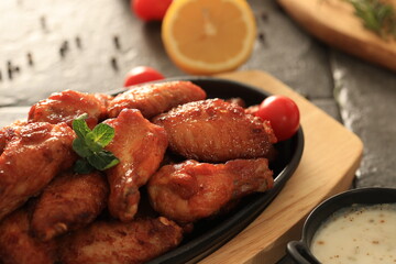 Korean-style fried chicken wings and drumsticks served in a skillet. Crispy texture with sweet and spicy glaze. A popular K-Food dish enjoyed at home and in restaurants.
