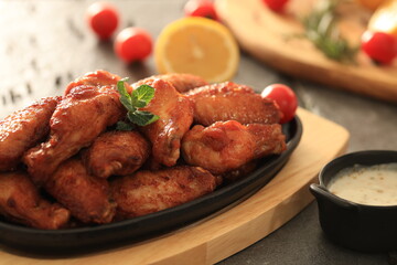 Korean-style fried chicken wings and drumsticks served in a skillet. Crispy texture with sweet and spicy glaze. A popular K-Food dish enjoyed at home and in restaurants.
