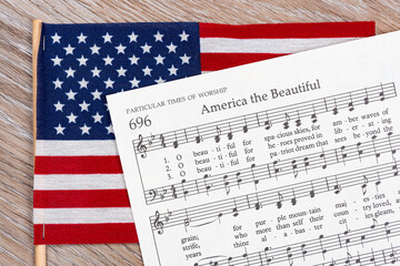 The America the Beautiful sheet music on top of an American Flag