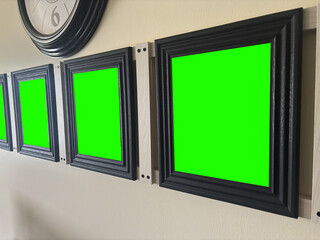 A Series of Green Screen Picture Frames on Wall