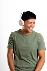 Young Latin man smiling outward from image, with wireless headphones