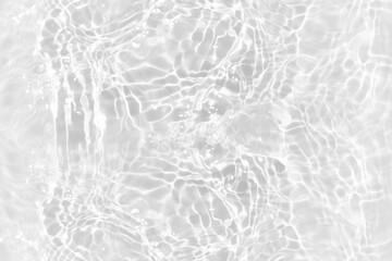 White water with ripples on the surface. Defocus blurred transparent white colored clear calm water surface texture with splashes and bubbles. Water waves with shining pattern texture background.