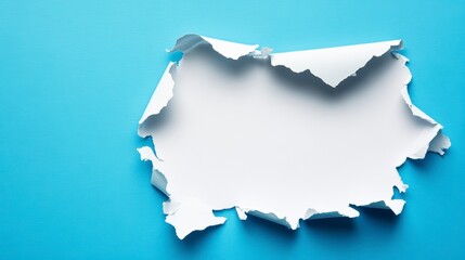 Torn white paper on blue background reveals empty space.