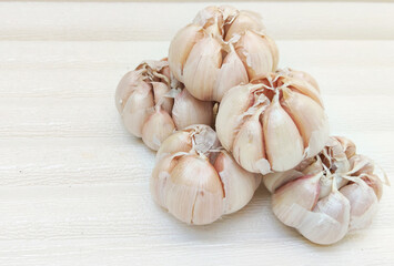 Stack of Five Fresh Garlic Bulbs on White Background