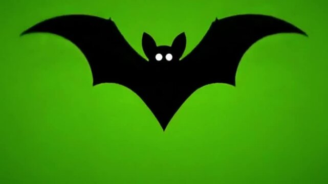 Black silhouette bat with glowing eyes against green background for halloween