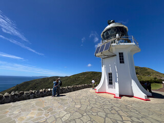Tourists visit at Cape Reinga Lighthouse at the edge of the Northland, New Zealand