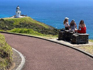 Tourists visit at Cape Reinga Lighthouse at the edge of the Northland, New Zealand