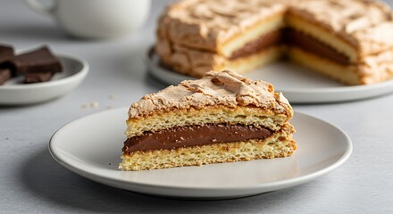 Chocolate Meringue Cake Slice: A delectable slice of chocolate meringue cake, featuring layers of light and airy meringue and rich chocolate filling, sits on a plate, ready to be enjoyed.