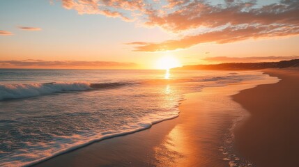 Warm golden sunset over tranquil ocean waves washing onto a serene beach