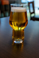 Freshly brewed light pils German beer in craft brewery served in beer glass poured from keg