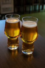 Freshly brewed light pils German beer in craft brewery served in beer glass poured from keg
