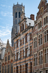 Fototapeta premium Medieval houses facades and rooftops and city tower with bells in the centre of Bruges, Flanders