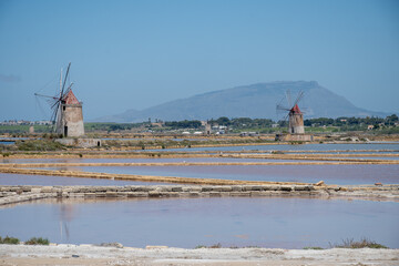 Sea saltworks, salt wind mills and pans, manually extracting high-quality salt, near Marsala and...